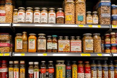 Shelves stocked with various pantry items and international spices